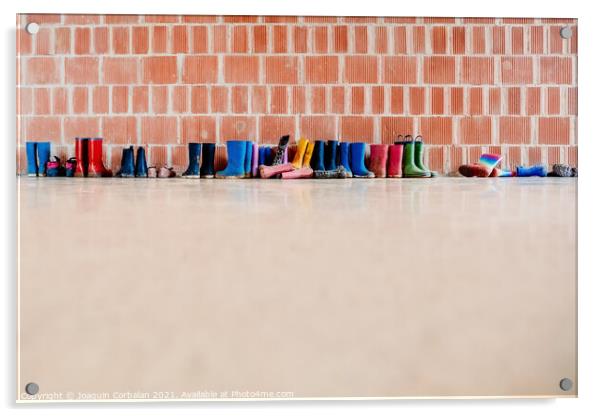 Rubber rain boots on the floor at the entrance to a college clas Acrylic by Joaquin Corbalan
