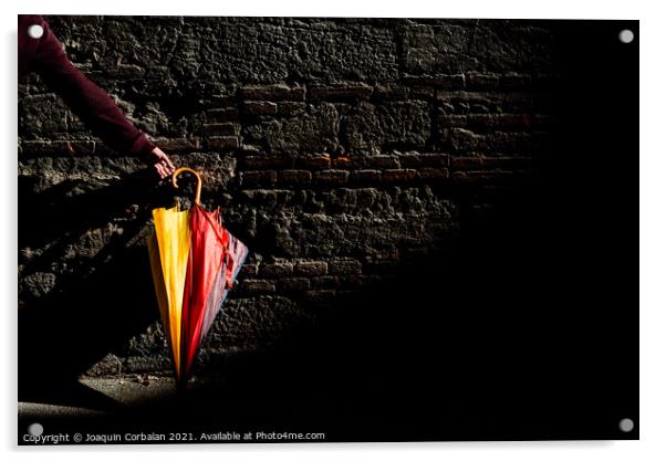 A beautiful colored umbrella rests folded against a brick wall i Acrylic by Joaquin Corbalan