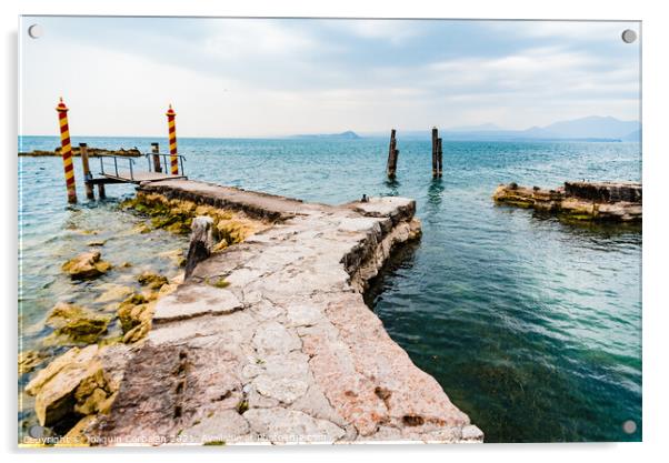 Old stone jetty at the tip of San Vigilio, on Lago di Garda with colorful mooring poles on Acrylic by Joaquin Corbalan