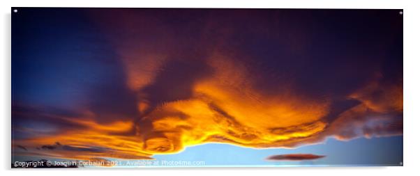 A large cloud with curious wavy shapes and warm reddish colors d Acrylic by Joaquin Corbalan
