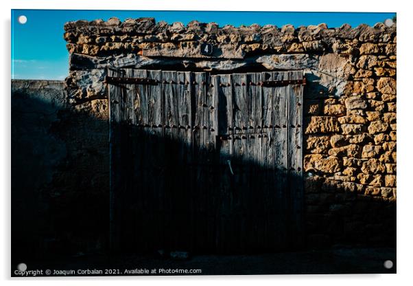 Old and decrepit wooden gate, half lit by the sun, in an unpopul Acrylic by Joaquin Corbalan