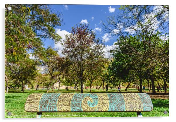 Wooden bench to rest decorated with a beautiful design of labyrinthine lines in a public garden. Acrylic by Joaquin Corbalan