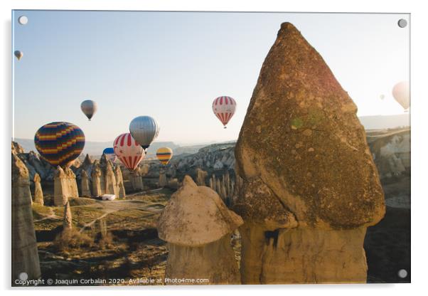 Goreme, Turkey - April 4, 2012: Hot air balloons for tourists flying over rock formations at sunrise in the valley of Cappadocia. Acrylic by Joaquin Corbalan