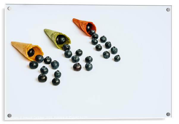 Ripe blueberries lined up in an empty ice cream cone, healthy desserts in summer, isolated on white background with copy space. Acrylic by Joaquin Corbalan