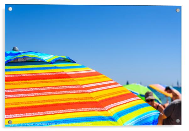 Colorful beach umbrella stuck in the sand surrounded by a group of bathers in summer, near the Mediterranean sea. Acrylic by Joaquin Corbalan