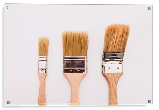 Three new painter brushes of various sizes isolated on white background. Acrylic by Joaquin Corbalan