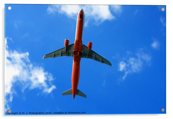 Passenger red airplane in the clouds and blue sky. Acrylic by M. J. Photography