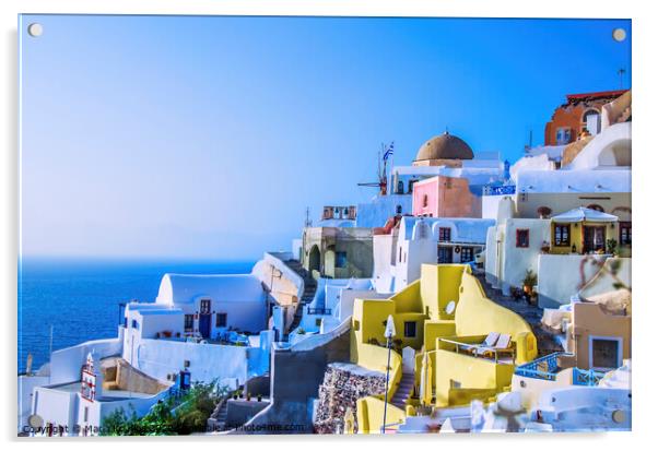At dusk the sun bathes the traditional and colorful Greek houses in the town of Oia Acrylic by Mario Koufios