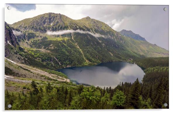 Wide angle top view of Morskie Oko naturally formed lake pond in Tatra Mountains in Poland. High mountain landscape with dramatic clouds covered with snow and trees at national park High Tatras Europe Acrylic by Arpan Bhatia