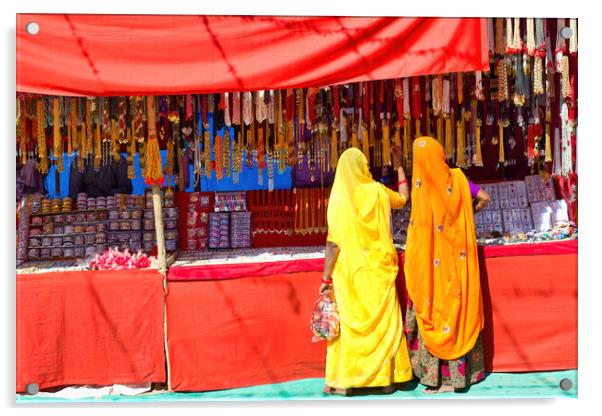 Couple of unidentified women in traditional hindu wear saree buying or shopping jewelery items in the commercial street of Pushkar fair in state of Rajasthan, India. Colorful Indian culture concept Acrylic by Arpan Bhatia