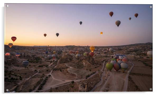 Cappadocia, Turkey - September 14, 2021: Wide angle aerial panoramic shot of colorful hot air balloons together floating in the sky at early morning sunrise horizon in Goreme national park Acrylic by Arpan Bhatia