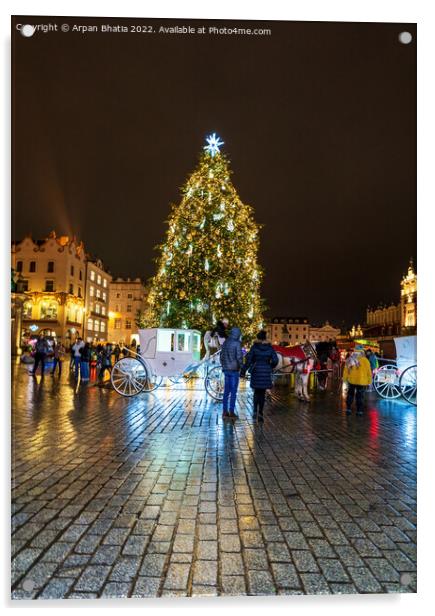 Krakow, Poland - January 08, 2022: Tourists in front of horse carriage against Christmas tree in the city center during night, City xmas decoration concept Acrylic by Arpan Bhatia