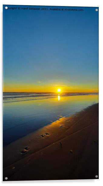 Wide sand beach reflecting orange sunset sunlight. Acrylic by Hanif Setiawan