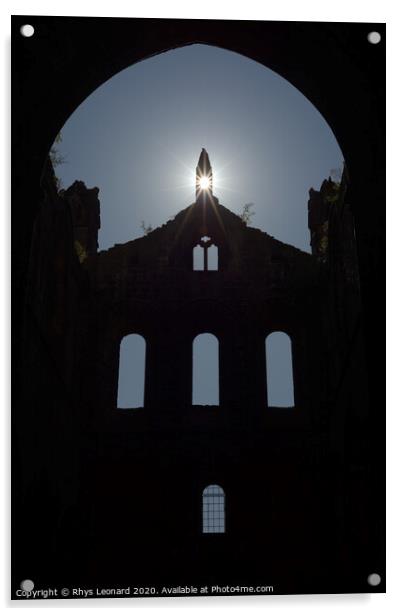 Sun flares through opening in the peak of a ruined wall of kirkstall abbey Acrylic by Rhys Leonard