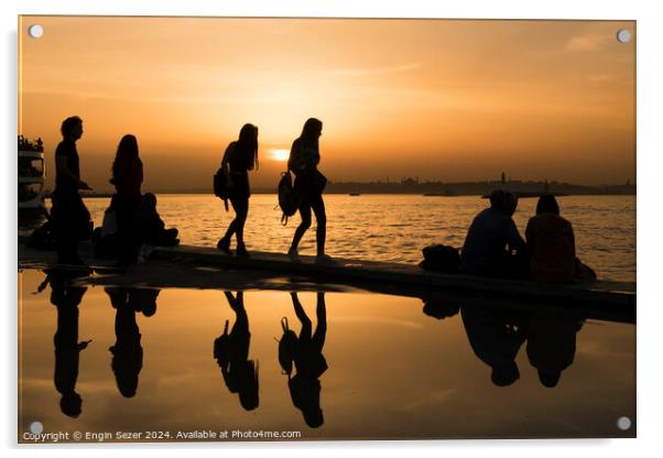Silhouettes of some young people with beautiful reflections on the water at sunset Acrylic by Engin Sezer