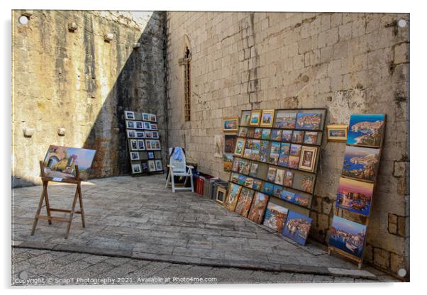 An artists stall in Dubrovnik's old town in a late summers afternoon, Croatia Acrylic by SnapT Photography