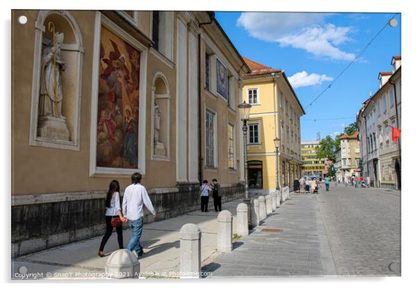 Tourists walking past the art on the wall at Ljubljana Cathedral, Slovenia Acrylic by SnapT Photography