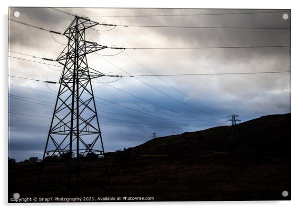 Electricity pylons in a field on a cloudy day in w Acrylic by SnapT Photography