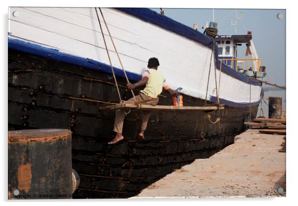 A ship repairer paints an old wooden ship in Mangalore, India Acrylic by Gordon Dixon