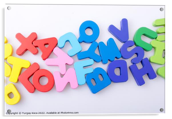 Colorful letter blocks scattered randomly on white Acrylic by Turgay Koca