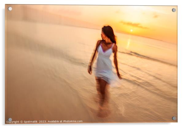 Motion blurred woman walking through waves at sunset Acrylic by Spotmatik 