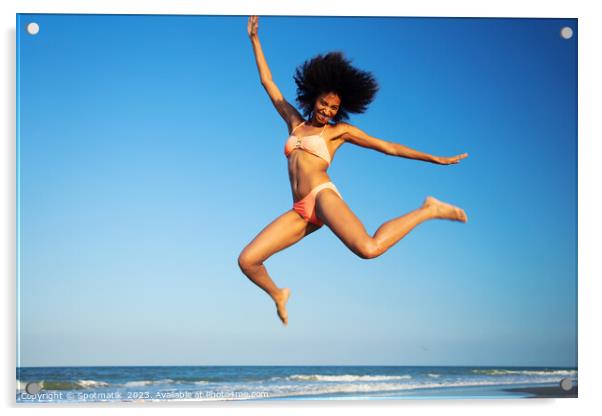 Fun loving Afro female jumping by the ocean Acrylic by Spotmatik 
