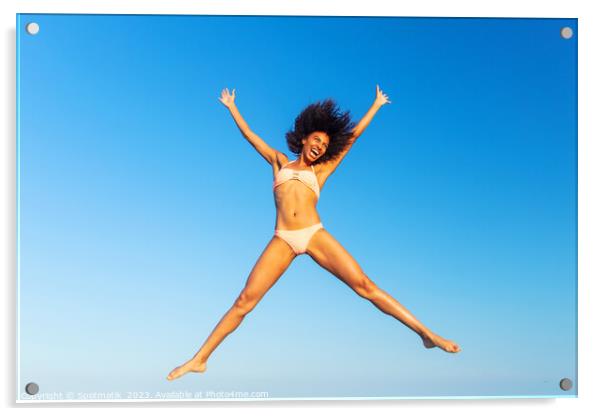 Carefree young African American woman jumping in swimwear Acrylic by Spotmatik 