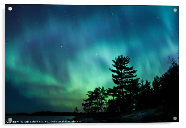 Northern lights erupt over a lake in Minnesota in a dark sky ove Acrylic by Rob Schultz