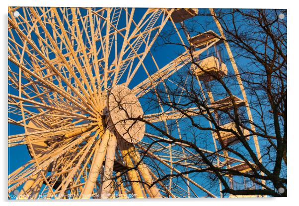 A ferris wheel against a clear blue sky at sunset, with trees in the foreground. Acrylic by Man And Life
