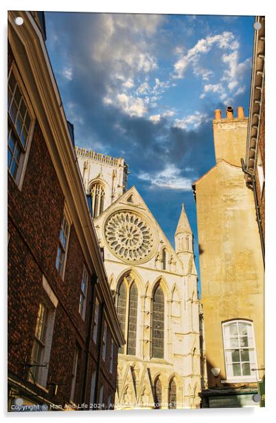 Historic cathedral facade with rose window, framed by old buildings against a blue sky with clouds in York, UK. Acrylic by Man And Life