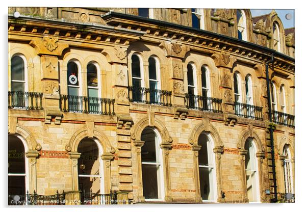 Vintage brick building facade with ornate windows and architectural details under a clear blue sky in Harrogate, England. Acrylic by Man And Life
