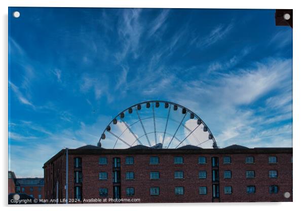 Ferris wheel silhouette against a blue sky with wispy clouds, framed by buildings in Liverpool, UK. Acrylic by Man And Life