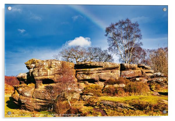 Scenic view of a rocky outcrop with a lone tree against a blue sky with a faint rainbow in the countryside at Brimham Rocks, in North Yorkshire Acrylic by Man And Life