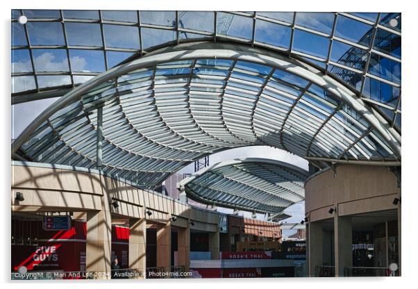 Modern glass ceiling architecture at a shopping mall with blue sky and clouds visible through the transparent structure in Leeds, UK. Acrylic by Man And Life