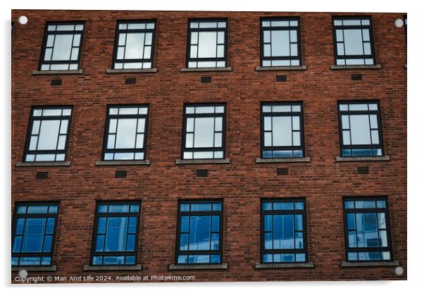Facade of a brick building with symmetrical windows reflecting the sky in Leeds, UK. Acrylic by Man And Life