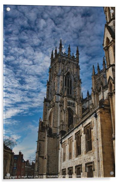 Gothic cathedral against a dramatic sky with fluffy clouds, showcasing intricate architecture and historical grandeur, ideal for travel and cultural themes in York, North Yorkshire, England. Acrylic by Man And Life