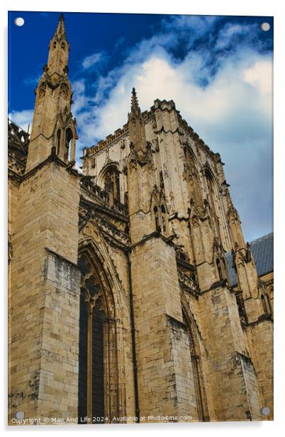 Gothic cathedral facade against a blue sky with clouds. The image captures the intricate architecture and towering spires of the historic religious building in York, North Yorkshire, England. Acrylic by Man And Life