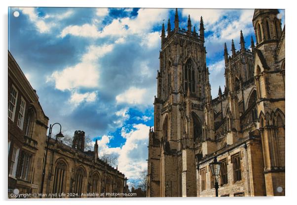 Dramatic sky over a majestic Gothic cathedral with intricate architecture, flanked by historic buildings, showcasing a blend of heritage and natural beauty in York, North Yorkshire, England. Acrylic by Man And Life