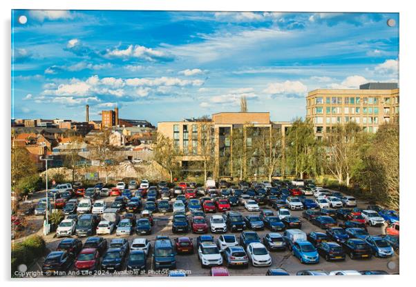 Urban parking lot filled with cars on a sunny day, with city buildings in the background and a clear blue sky overhead in York, North Yorkshire, England. Acrylic by Man And Life