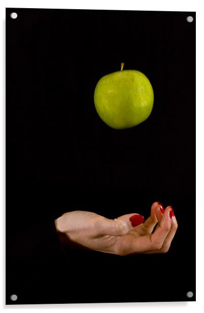 Female hand throwing a green apple Acrylic by Gabor Pozsgai