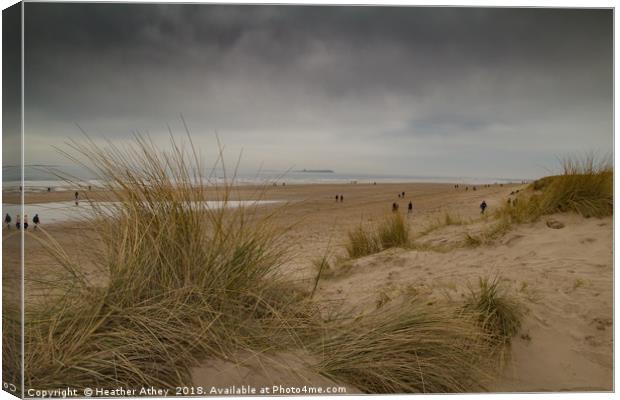 Moody day at Bamburgh beach, Northumberland Canvas Print by Heather Athey