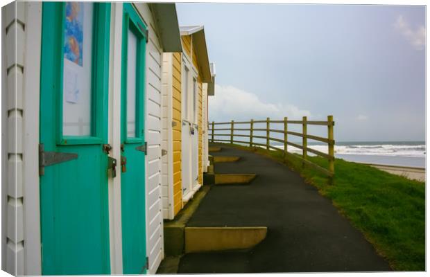 Beach Huts, Colored Chalets Canvas Print by Dave Bell