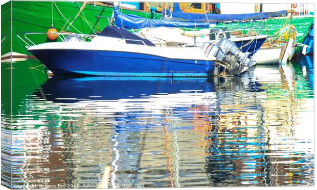 Stunning reflections of blue and green boats in th Canvas Print by Dave Bell