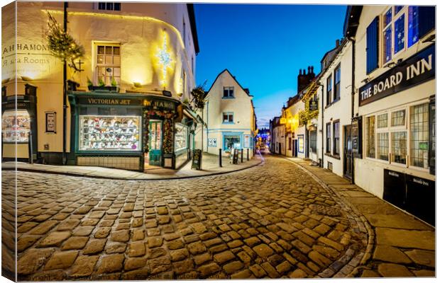 Christmas decorations on Church Street, Whitby, North Yorkshire Canvas Print by Martin Williams