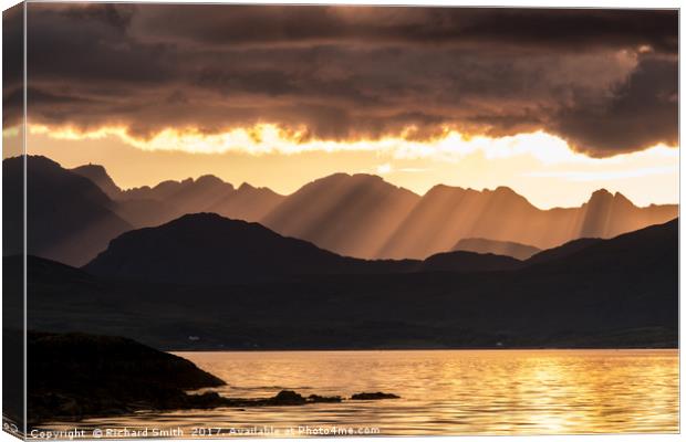 Evening crepuscular rays over the Cuillin Hills. Canvas Print by Richard Smith