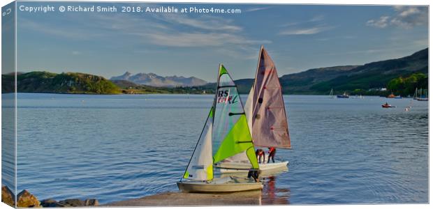 Two sailing dinghies return to the Sailing Club Canvas Print by Richard Smith