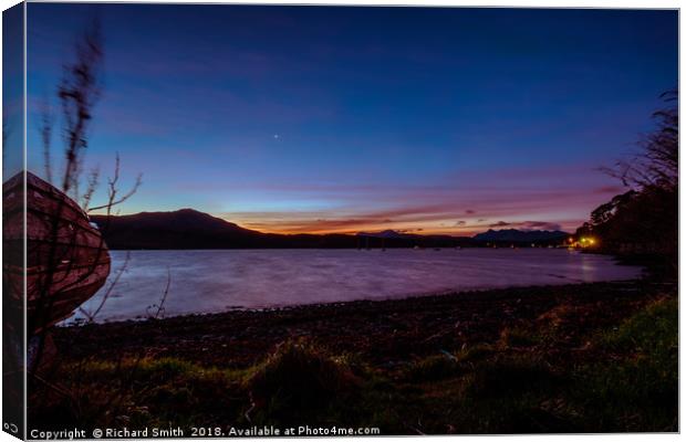 Loch Portree sunrise viewed from the grassy shore  Canvas Print by Richard Smith