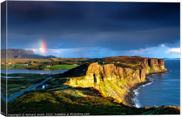 The end of a rainbow at sunrise, the cliffs of Kilt Rock with loch Mealt behind. Canvas Print by Richard Smith