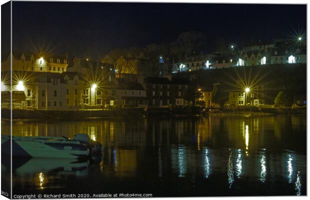 Illuminated buildings at the beach end of Portree Harbour Canvas Print by Richard Smith