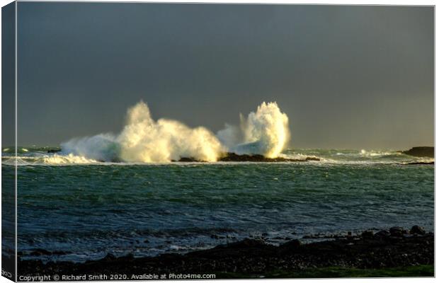 Large wave breaks over rocks close to Staffin Pier. Canvas Print by Richard Smith